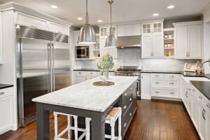 A modern kitchen featuring white cabinets and sleek black countertops.
