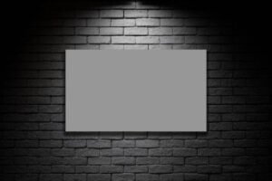 A blank white board mounted on a brick wall, serving as a canvas for wall painting.