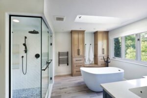A clean bathroom featuring a spacious tub and a modern shower, showcasing a bright and inviting atmosphere designed by a professional bath remodel contractor.