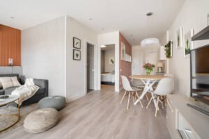 Stylish living room and dining area in a modern apartment, highlighting recent home remodeling with elegant furnishings.