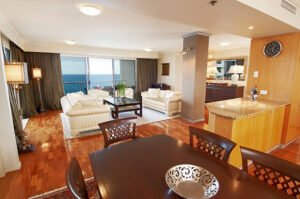 Custom home remodeling showcases a living room and dining area with a beautiful ocean view.