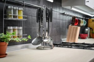  A renovated kitchen featuring pots and pans neatly arranged on the counter, showcasing modern design and functionality.