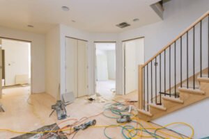  A room featuring a staircase and polished wood flooring, showcasing a modern home remodeling near me .